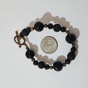 Black and gold tone bead bracelet